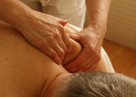 Close-up of a therapist giving a relaxing shoulder massage, enhancing wellness and stress relief.