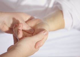 Relaxing hand massage therapy session close-up with gentle touch and care.